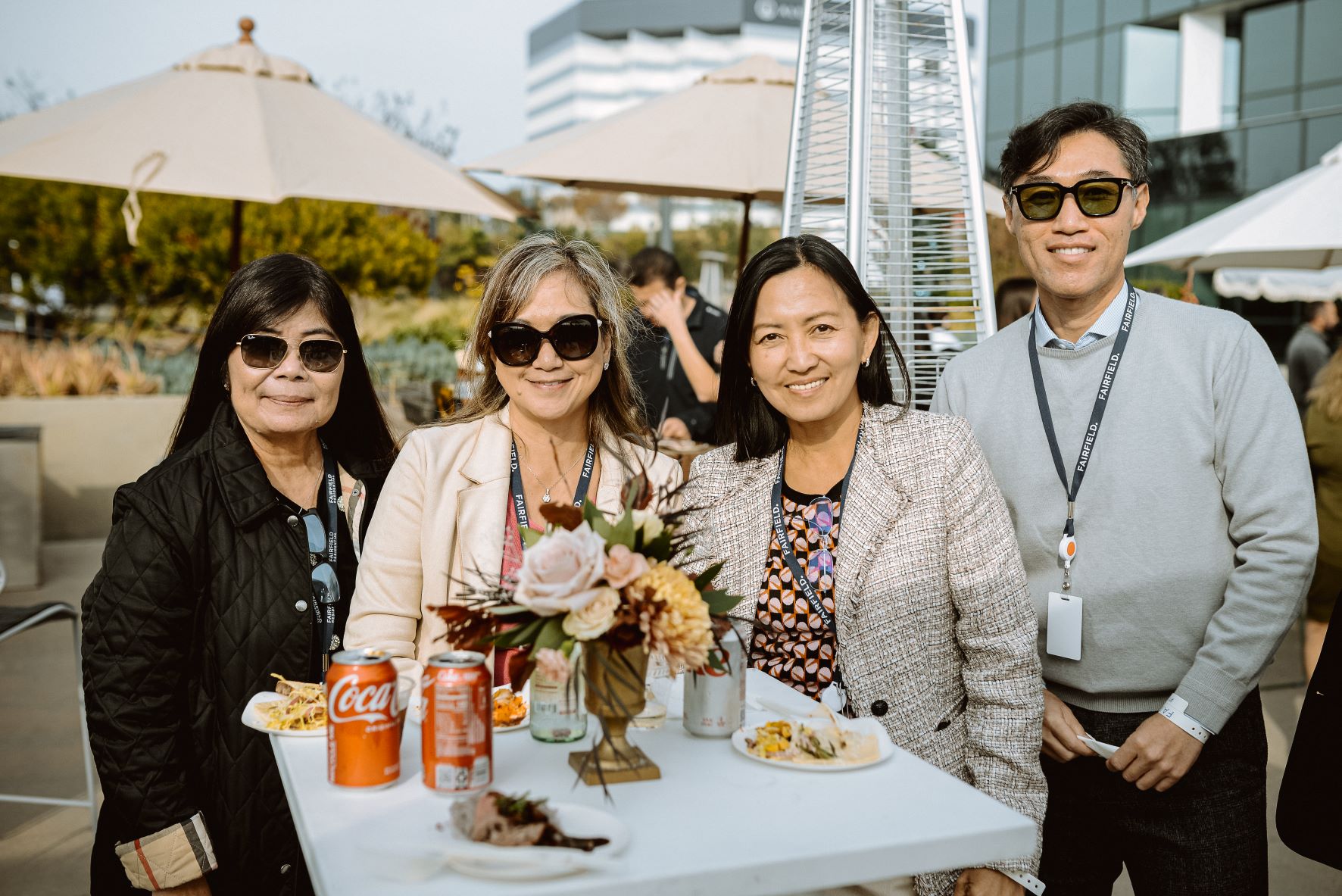 A group of four Fairfield associates smile for the camera at a corporate office event.