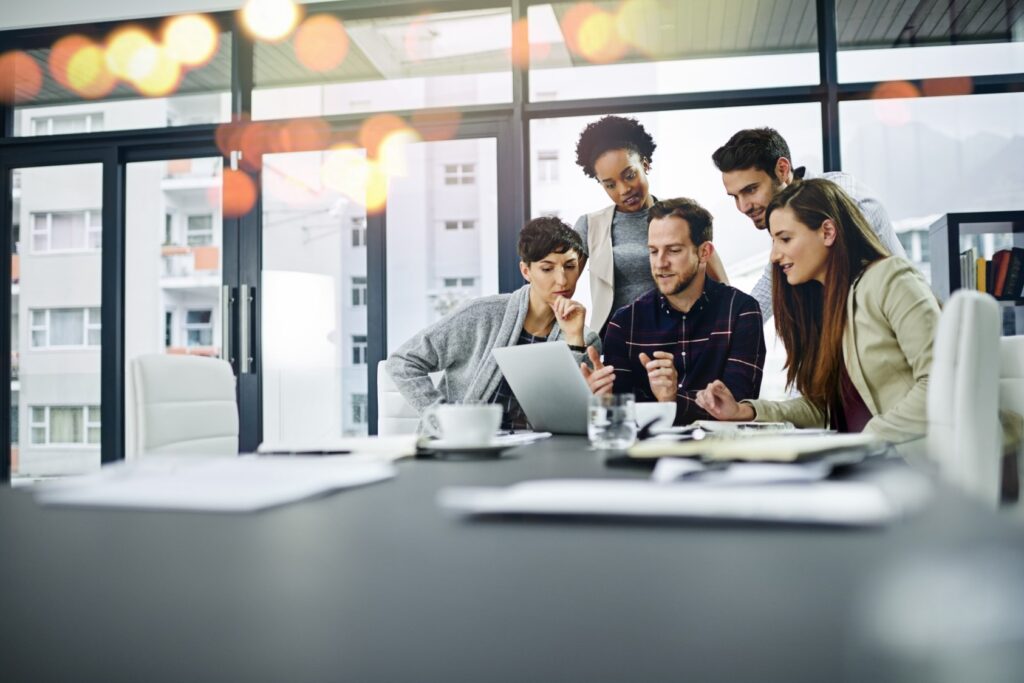 Associates in a meeting in a conference room. There are many benefits of working at Fairfield, and team work is one of them.