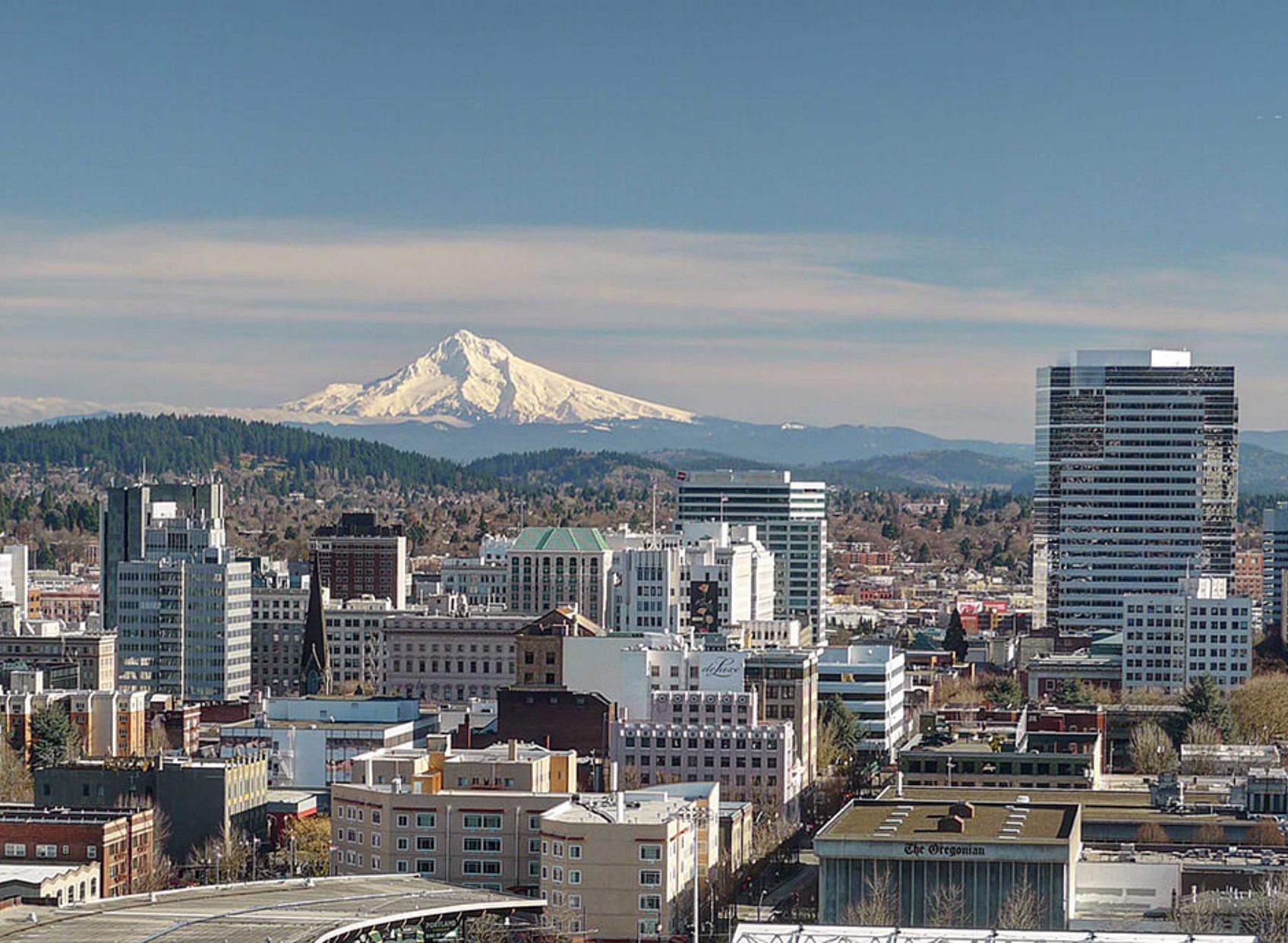 View of Portland's city skyline with a snow capped mountain in the distance