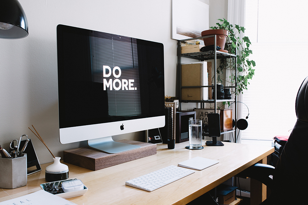 Home office work desk with a large monitor.