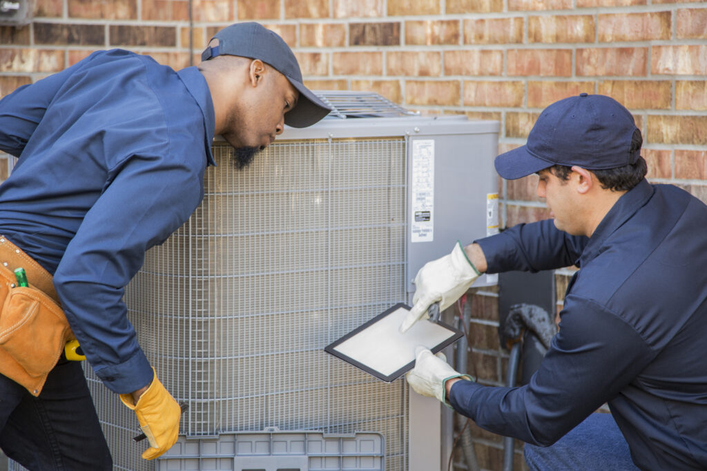 Maintenance team working together on AC