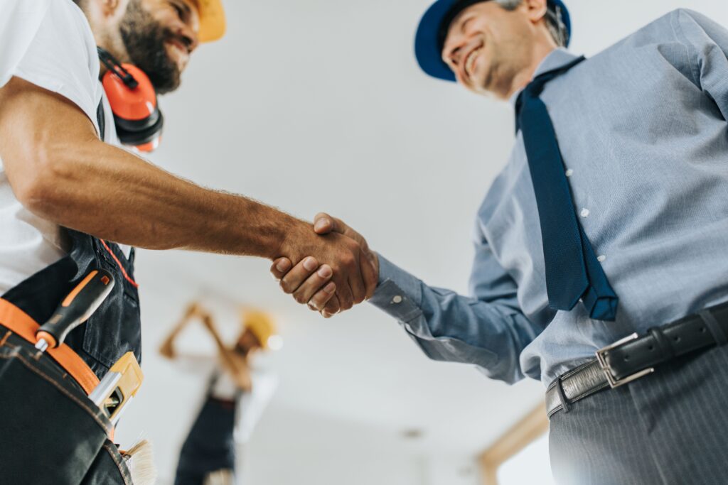 Construction team and manager handshake