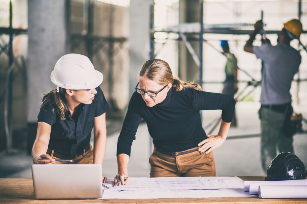 Construction team reviewing blue prints