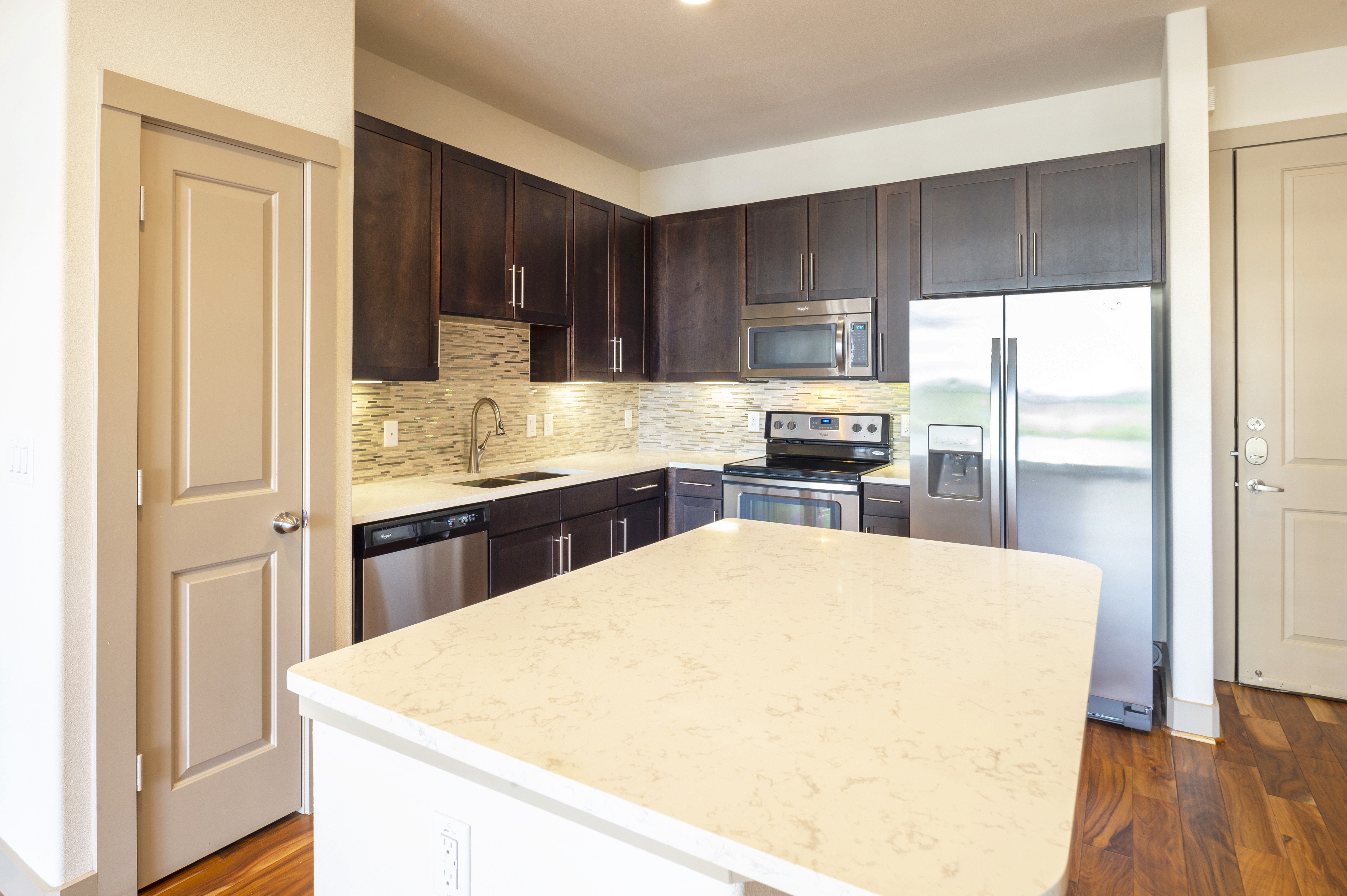 A large granite kitchen island at Block 334 Apartments.