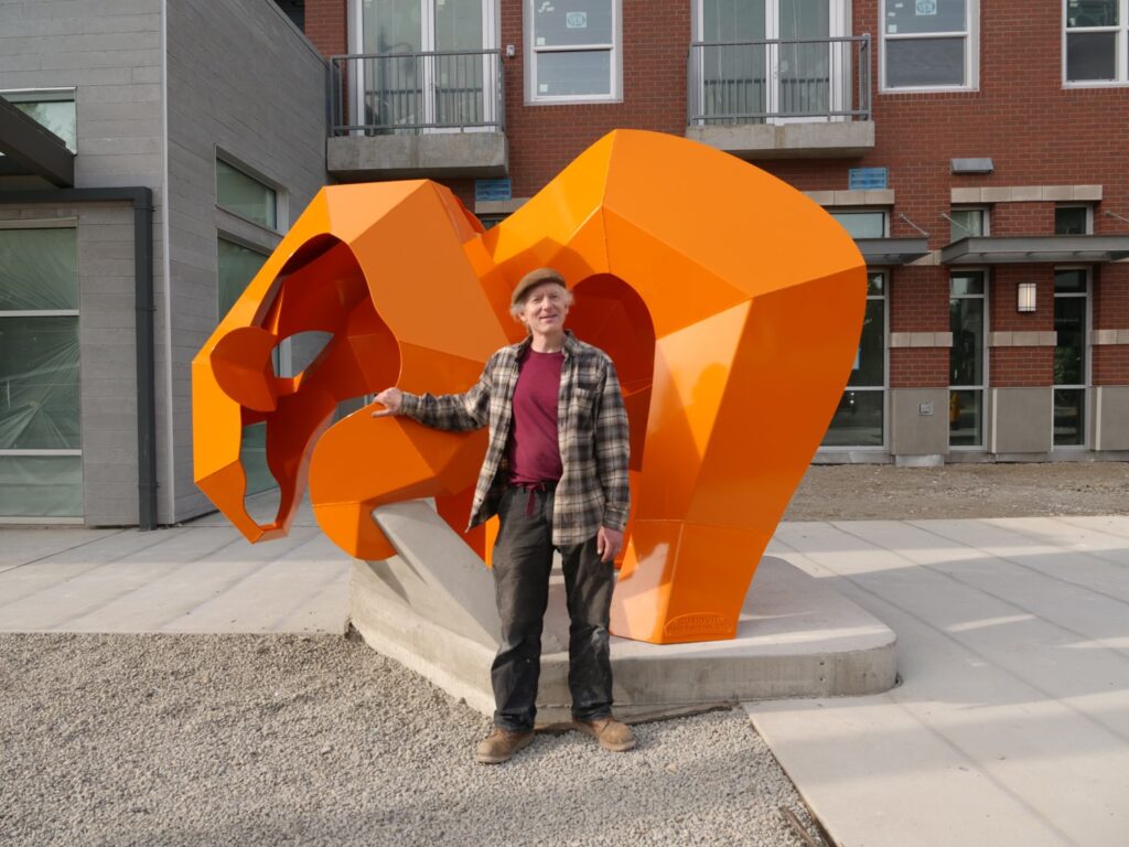 Artist Matt Babcock in front of "Curious?" 