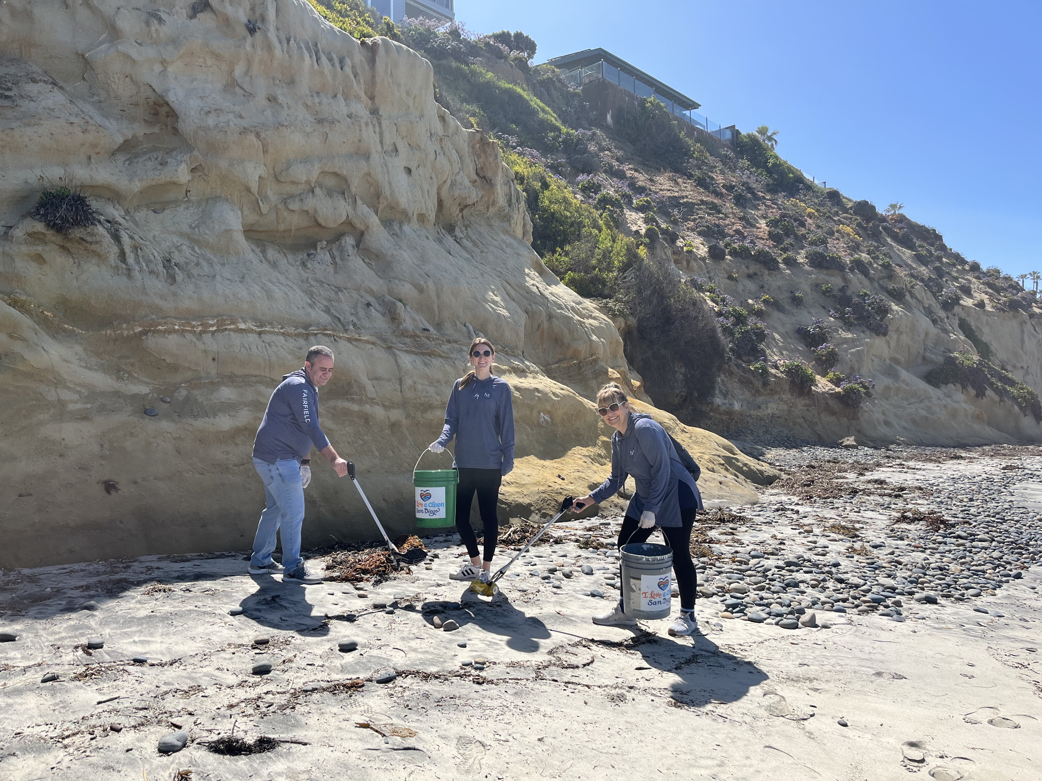 Fairfield associates volunteering by picking up trash.