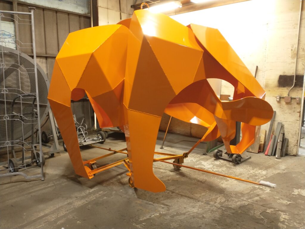 "Curious?" orange bear sculpture in the artist's studio