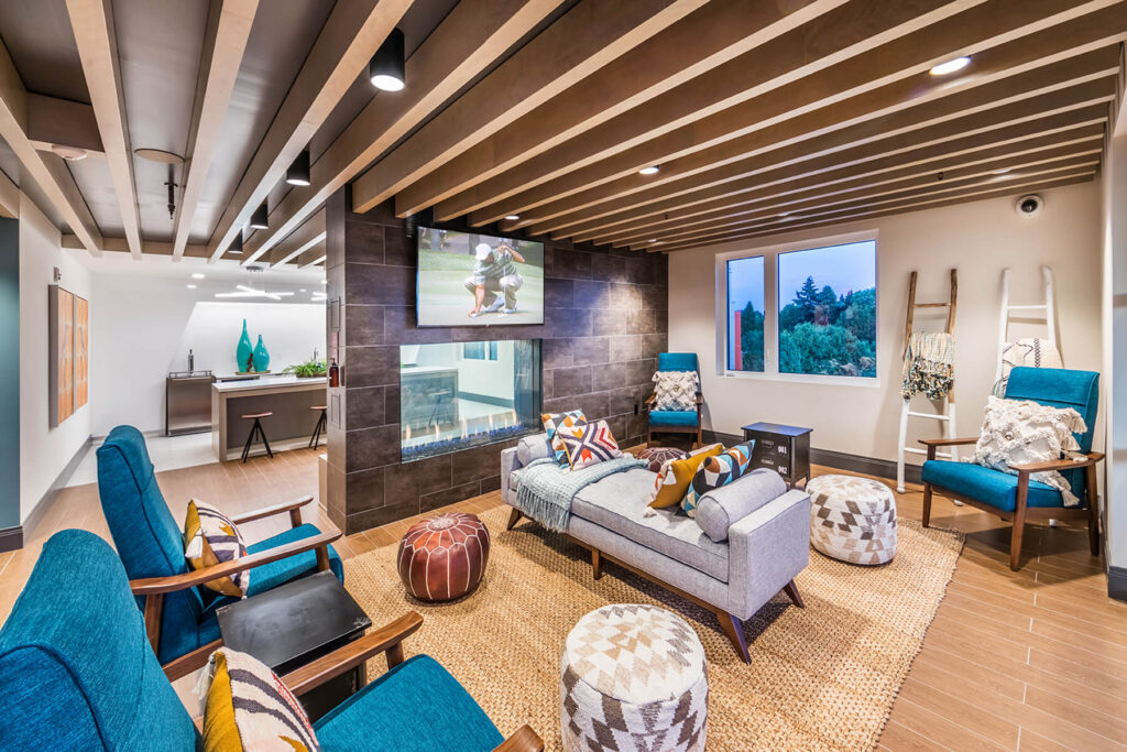 resident lounge seating area and fireplace at sandy 28 apartments in portland or