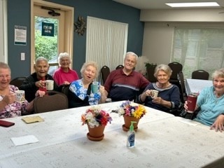 Seniors at Alderwood Court Apartments host a social event.