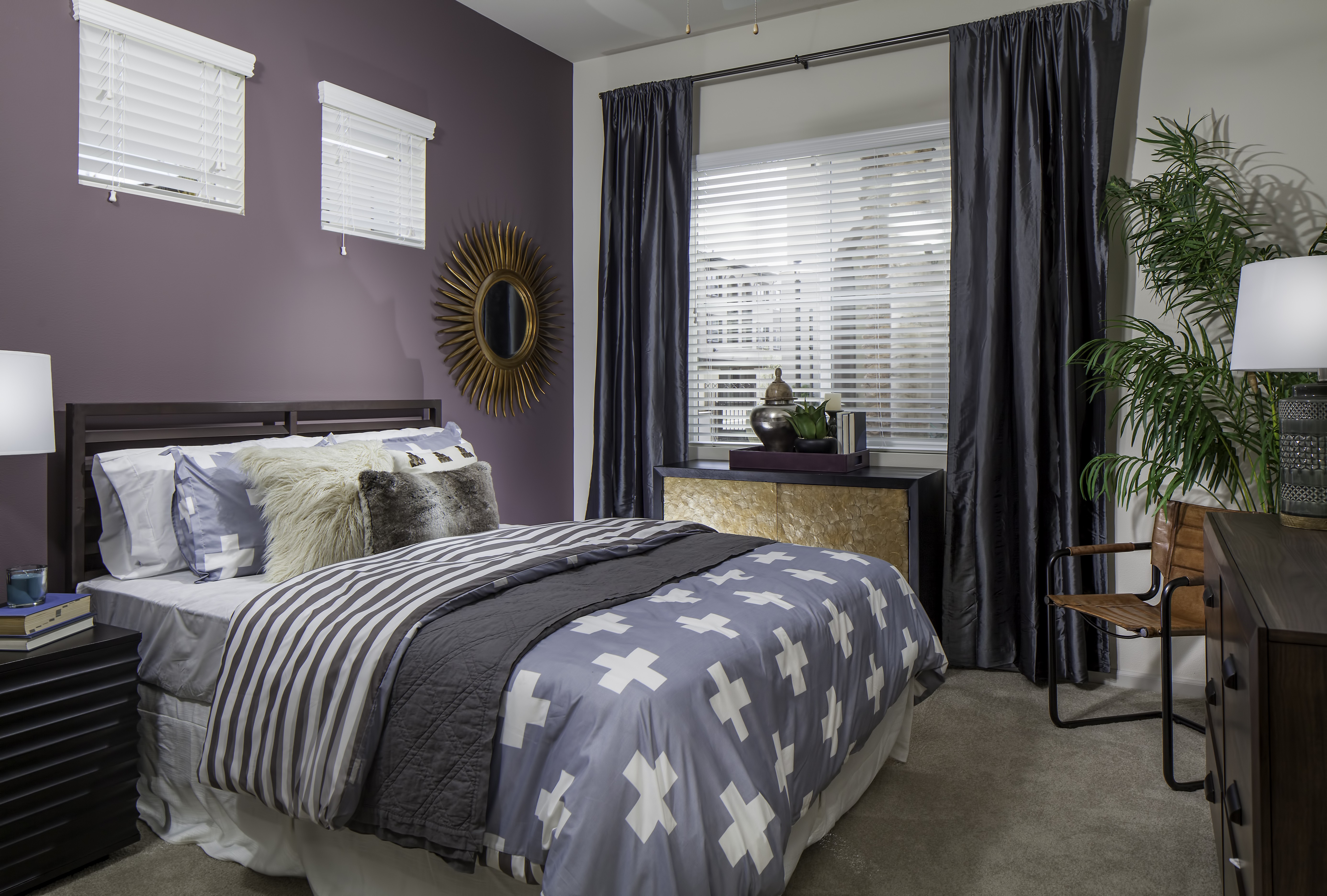 A cool-toned, decorated bedroom at Skye Apartments in Vista CA