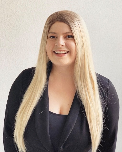 A blonde Fairfield associate smiles for the camera.