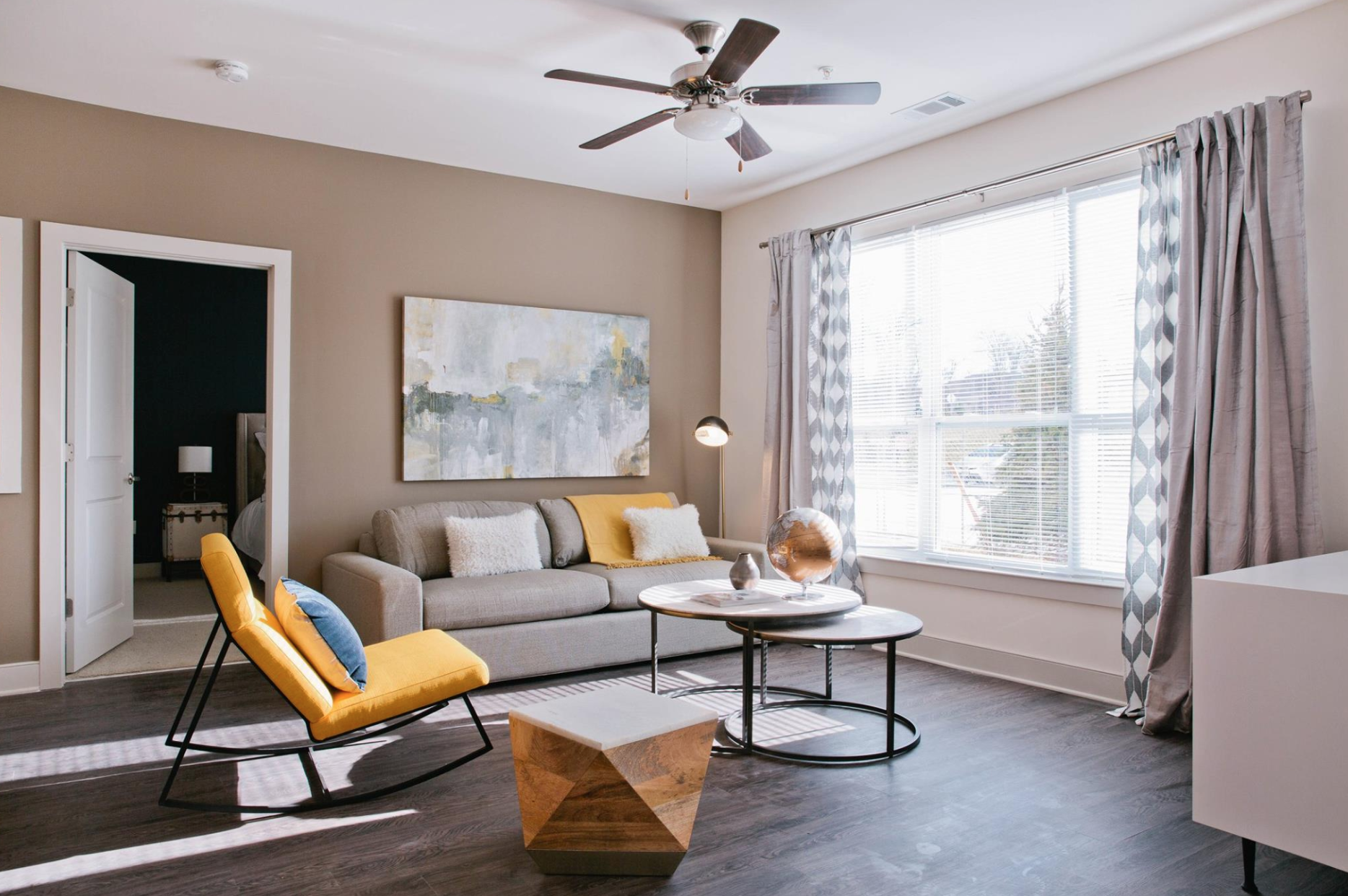 Nicely decorated living room with lots of natural light at Talia Apartments